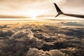 Airplane Passenger View of Sunset Over Puffy Clouds Royalty Free Stock Photo