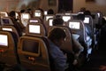 Airplane passengers watch TV on the way from Los Angeles to Seoul South Korea - November 2013