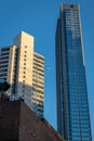 An airplane passes between two tall New York City skyscrapers on a late summer afternoon Royalty Free Stock Photo