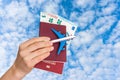 Airplane, passport and money in female hand - travelling concept Royalty Free Stock Photo