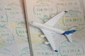 Airplane on passport pages with a visa. Close up Royalty Free Stock Photo