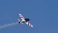 Airplane performs stunts in the cloudless blue sky