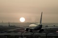 Airplane photographed from behind landing at Seville airport at sunset Royalty Free Stock Photo