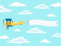 Airplane with pilot and advertising banner in the cloudy sky Royalty Free Stock Photo