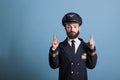 Airplane pilot pointing up with index fingers, advertising product