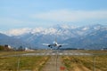 Airplane plane passenger jet landing in airport with scenery mountains view. Royalty Free Stock Photo