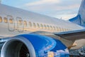 Airplane portholes, engine, tail. At sunset at the airport Royalty Free Stock Photo