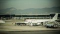 Airplane preparation on the airport field. Barcelona international airport. Photography with vintage effect