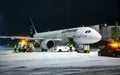 Airplane preparation to fly early winter morning