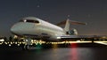 Airplane or private jet is on the airport runway at night. Airplane taking off the airport at night Royalty Free Stock Photo