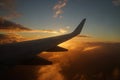 Airplane`s wing with sunset and sky