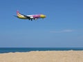 Airplane Nok Air over sea and sandy beach