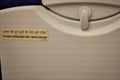 Airplane seat tray table with English and Hindu captions Royalty Free Stock Photo