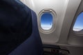 Airplane seat and window inside an aircraft. Royalty Free Stock Photo