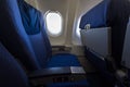 Airplane seat and window inside an aircraft. Royalty Free Stock Photo