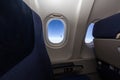 Airplane seat and window inside an aircraft. Royalty Free Stock Photo