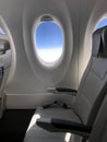 Airplane seat and window inside an aircraft Royalty Free Stock Photo