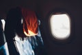 Airplane seat and window inside an aircraft with view of clouds. Royalty Free Stock Photo