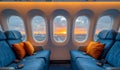 Airplane seat and window inside aircraft with view on sunset Royalty Free Stock Photo