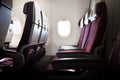 Airplane seats in the cabin with window in the morning. Royalty Free Stock Photo