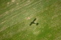 Airplane shadow on green field