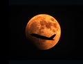 Airplane silhouette over Full Moon Royalty Free Stock Photo
