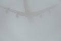 Airplane silhouette in the cloudy skies Royalty Free Stock Photo