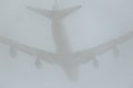 Airplane silhouette in the cloudy skies