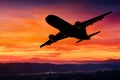 Airplane silhouette in the sky at sunset