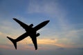 Airplane silhouette in the sky at sunset. Royalty Free Stock Photo
