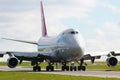 the airplane is sitting on the runway next to some grass