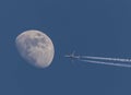 Airplane on sky in front of moon Royalty Free Stock Photo