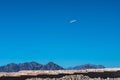 An airplane in the sky, flying over the Sinai mountains Royalty Free Stock Photo