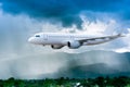 Airplane in the sky with rain over mountain, The plane flies in terrible thunderstorm,Concept of climate weather