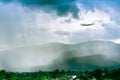 Airplane in the sky with rain over mountain, The plane flies in terrible thunderstorm,Concept of climate weather