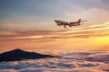 Airplane in the sky at sunset - Passenger Airliner aircraft Royalty Free Stock Photo