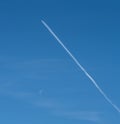 Airplane soaring through the clear blue sky, leaving behind long white contrails in their wake
