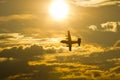 Airplane soaring through vibrant sunset cloudscape freely Royalty Free Stock Photo