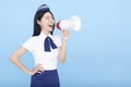 Airplane stewardess  woman isolated on blue background shouting through the megaphone Royalty Free Stock Photo
