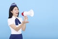 Airplane stewardess  woman shouting through the megaphone isolated on blue background Royalty Free Stock Photo