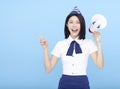 Airplane stewardess  woman shouting through the megaphone isolated on blue background Royalty Free Stock Photo