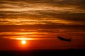 Airplane at sunset sky in the air with space for text. Silhouette of a big passenger aircraft in sun light. transportation Royalty Free Stock Photo