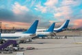 Airplane tail view at sunset at the airport. Royalty Free Stock Photo