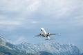 Airplane take off. Mountains view.