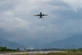 Airplane taking off from the airport, mountains on background. Transportation concept