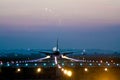 Airplane taking off at an airport at night Royalty Free Stock Photo