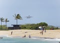 Airplane taking off over the beach