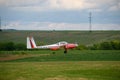 Airplane taking off over a greenery landscape at Hangariada aeronautical festival in Romania