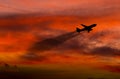 Airplane taking off at sunset. Silhouette of a big passenger or cargo aircraft, airline. Transportation Royalty Free Stock Photo