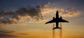 Airplane taking off at sunset. Silhouette of a big passenger or cargo aircraft, airline. Transportation Royalty Free Stock Photo